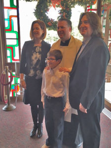 family with Fr. Fisher at baptism