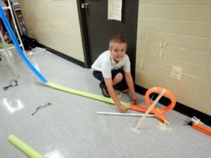 boy constructing track at STEM club