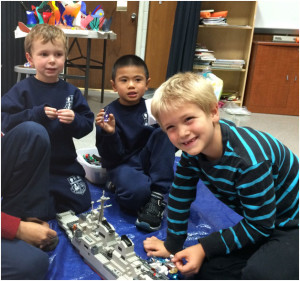 boys building lego airplane